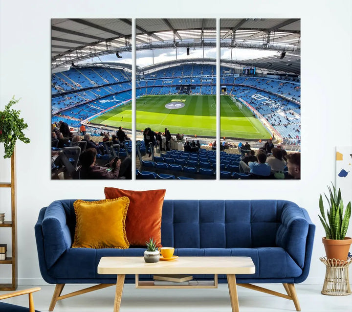 A captivating Manchester City Etihad Stadium Wall Art Canvas Print graces the living room, showcasing a football stadium with an empty field in a gallery-quality finish.