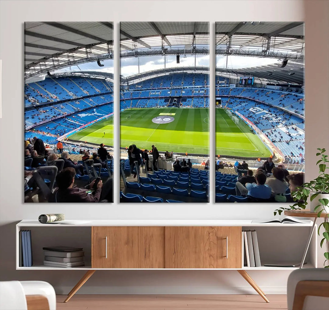 A captivating Manchester City Etihad Stadium Wall Art Canvas Print graces the living room, showcasing a football stadium with an empty field in a gallery-quality finish.