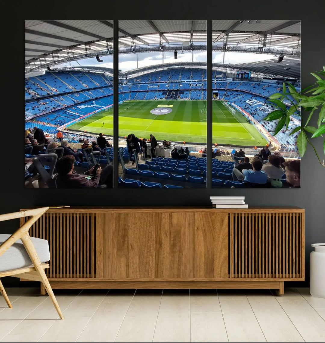 A captivating Manchester City Etihad Stadium Wall Art Canvas Print graces the living room, showcasing a football stadium with an empty field in a gallery-quality finish.