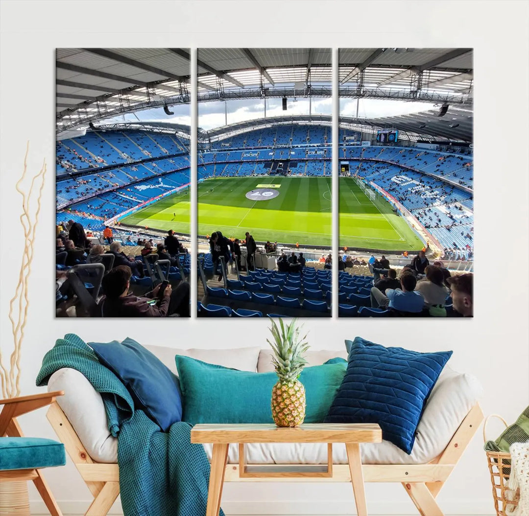 A captivating Manchester City Etihad Stadium Wall Art Canvas Print graces the living room, showcasing a football stadium with an empty field in a gallery-quality finish.