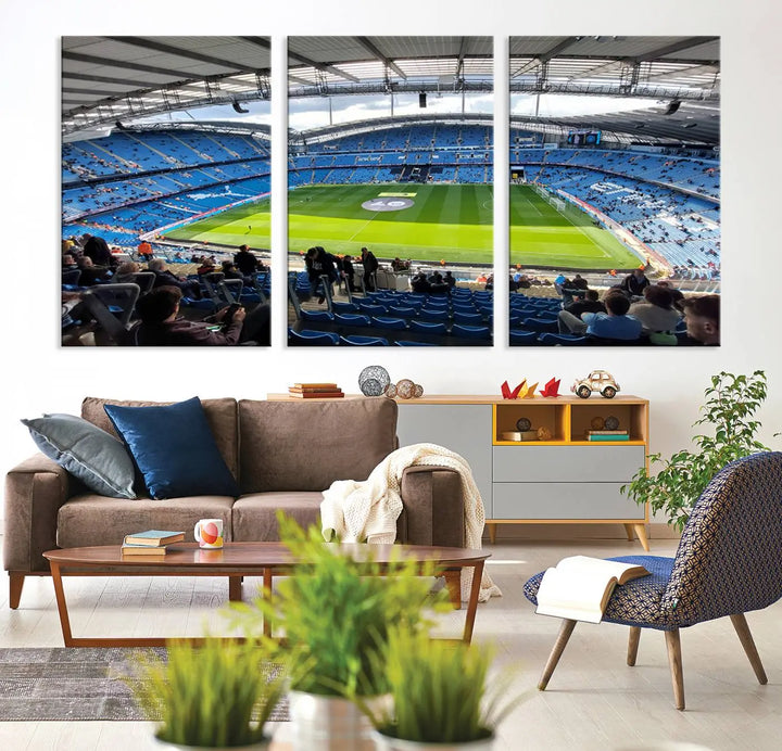 A captivating Manchester City Etihad Stadium Wall Art Canvas Print graces the living room, showcasing a football stadium with an empty field in a gallery-quality finish.