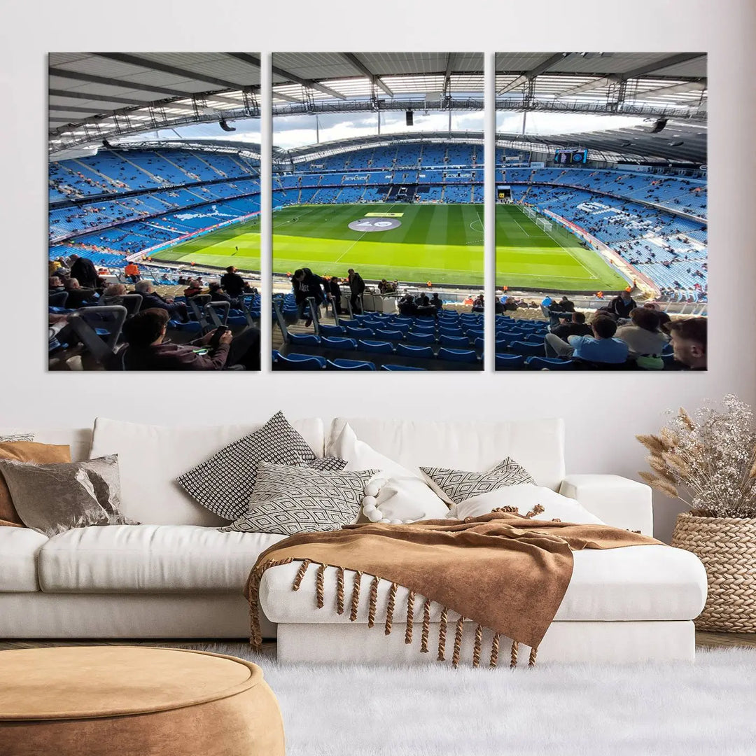 A captivating Manchester City Etihad Stadium Wall Art Canvas Print graces the living room, showcasing a football stadium with an empty field in a gallery-quality finish.