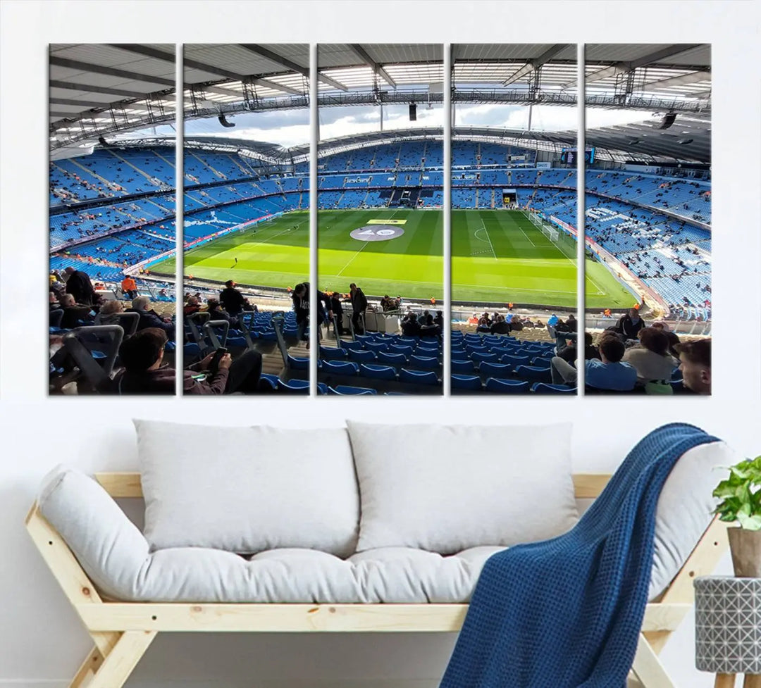 A captivating Manchester City Etihad Stadium Wall Art Canvas Print graces the living room, showcasing a football stadium with an empty field in a gallery-quality finish.