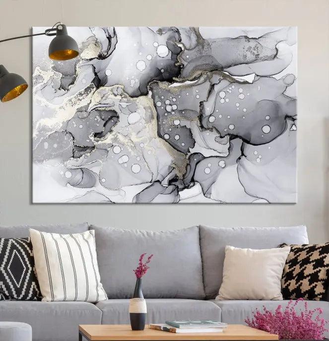 The "Marble Fluid Effect Wall Art Abstract Canvas Wall Art Print" forms a stunning abstract triptych with black, gray, and gold patterns in a modern living room. These museum-quality pieces include a UV-protective coating to ensure lasting beauty.