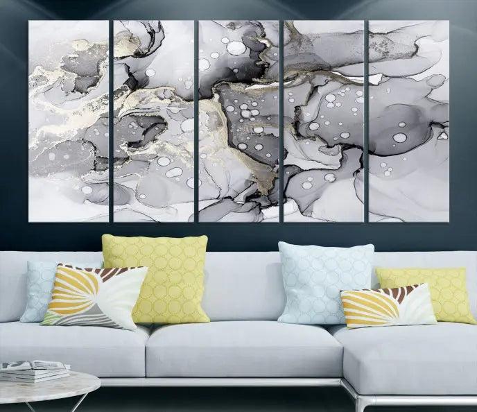 The "Marble Fluid Effect Wall Art Abstract Canvas Wall Art Print" forms a stunning abstract triptych with black, gray, and gold patterns in a modern living room. These museum-quality pieces include a UV-protective coating to ensure lasting beauty.