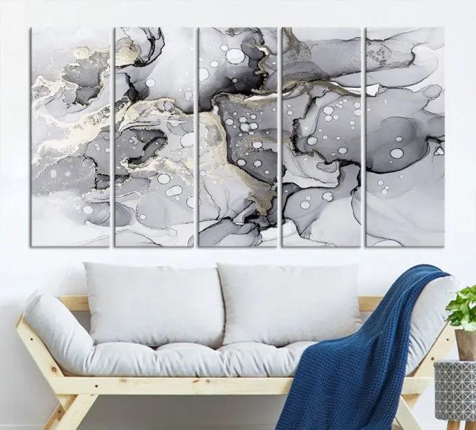 The "Marble Fluid Effect Wall Art Abstract Canvas Wall Art Print" forms a stunning abstract triptych with black, gray, and gold patterns in a modern living room. These museum-quality pieces include a UV-protective coating to ensure lasting beauty.