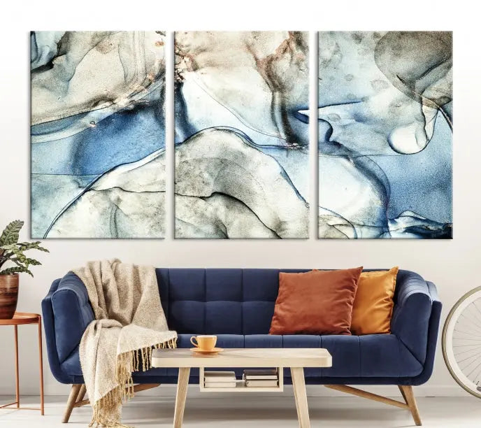 Introducing the Marble Fluid Effect Wall Art Abstract Canvas Wall Art Print, featuring a stunning triptych design with blue and beige swirls on museum-quality canvas.