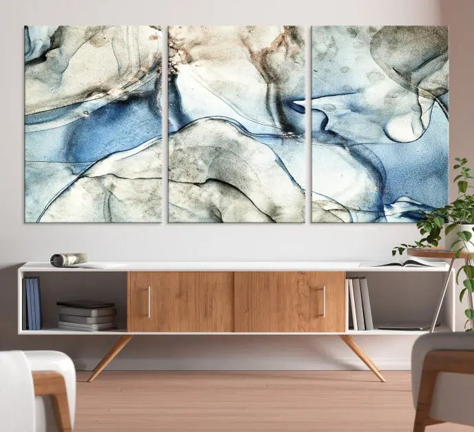 Introducing the Marble Fluid Effect Wall Art Abstract Canvas Wall Art Print, featuring a stunning triptych design with blue and beige swirls on museum-quality canvas.