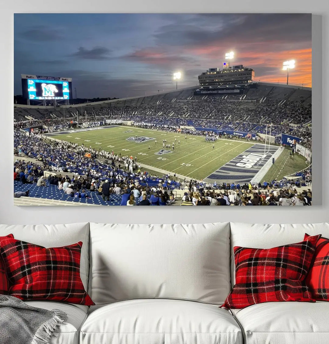 The "Memphis Tigers Football Team Print" is a triptych canvas, printed in high-resolution with vibrant colors, spotlighting the Memphis Simmons Bank Liberty Stadium at sunset. The scene beautifully captures a thrilling game in progress and the lively crowd, all rendered on museum quality canvas.