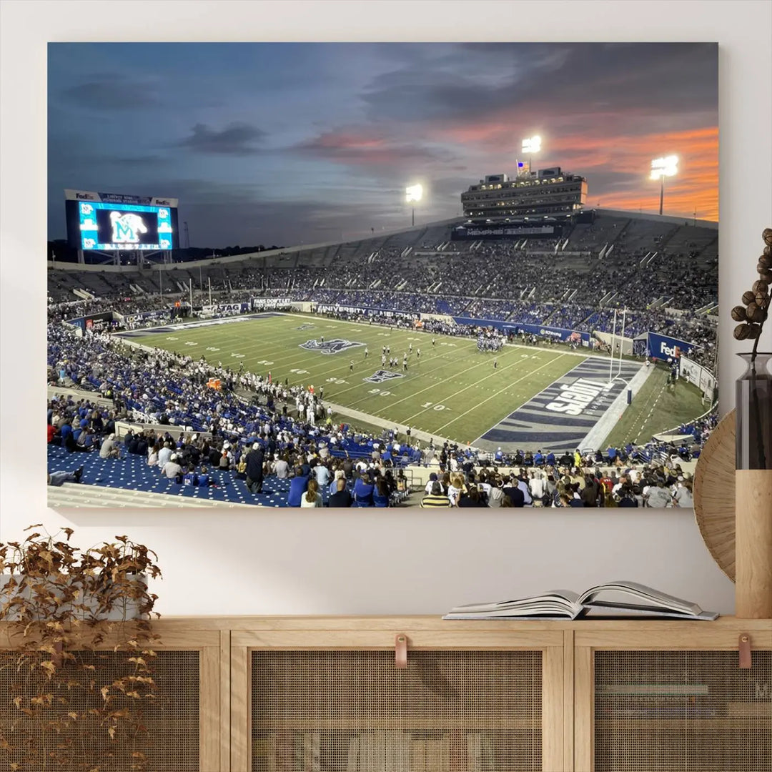 The "Memphis Tigers Football Team Print" is a triptych canvas, printed in high-resolution with vibrant colors, spotlighting the Memphis Simmons Bank Liberty Stadium at sunset. The scene beautifully captures a thrilling game in progress and the lively crowd, all rendered on museum quality canvas.