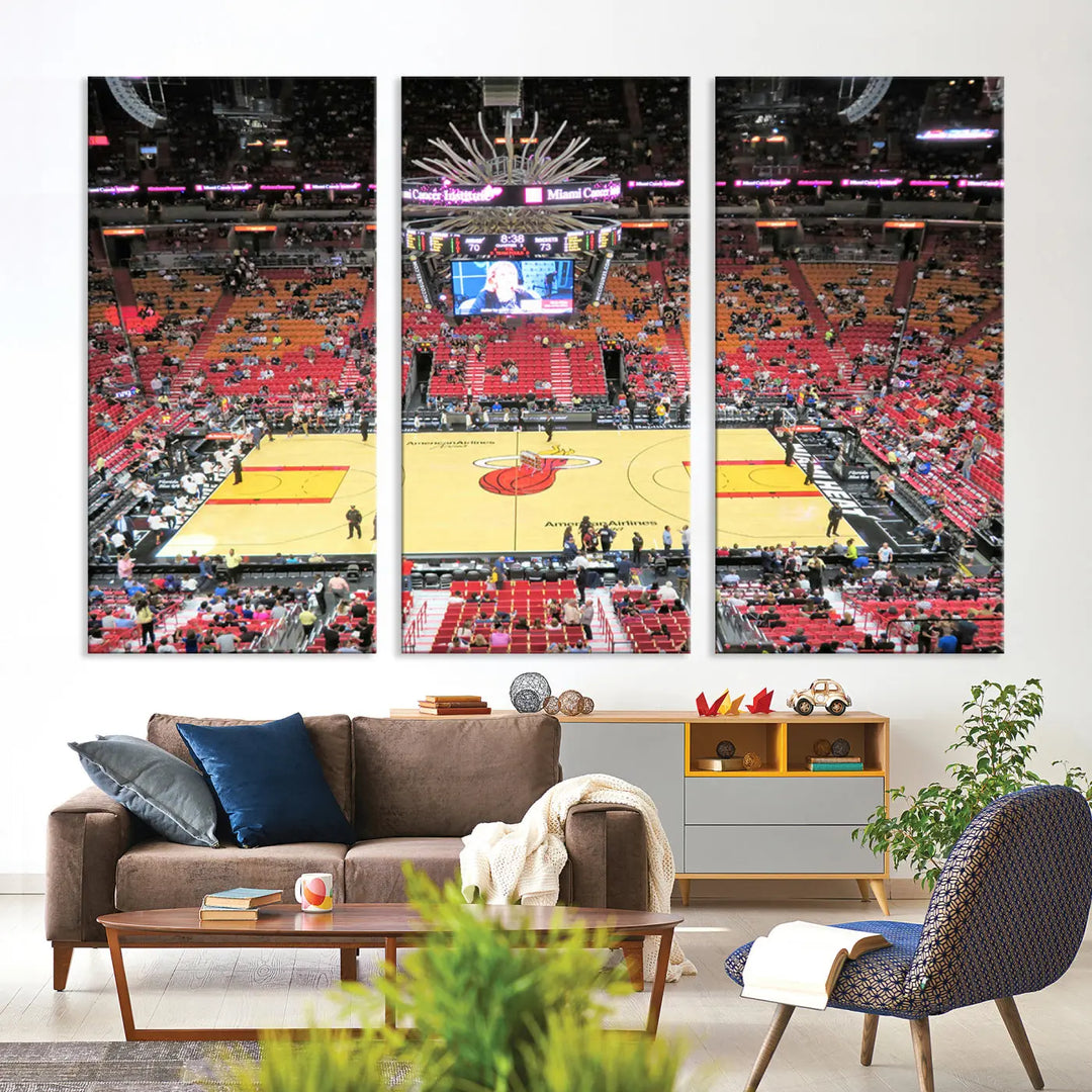 The living room features a gallery-quality finish triptych wall art of the Miami Heat basketball team's Kaseya Center Stadium.