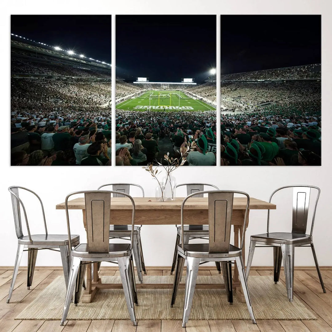 The Michigan State Spartans Football Team Print features an impressive depiction of East Lansing's Spartan Stadium at night, packed with enthusiastic fans. This captivating wall art boasts a gallery-quality finish that enchants any viewer.