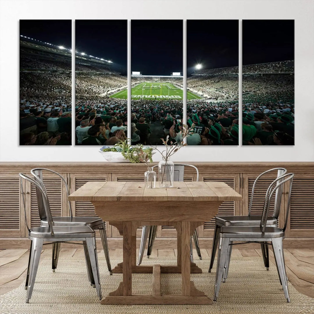 The Michigan State Spartans Football Team Print features an impressive depiction of East Lansing's Spartan Stadium at night, packed with enthusiastic fans. This captivating wall art boasts a gallery-quality finish that enchants any viewer.