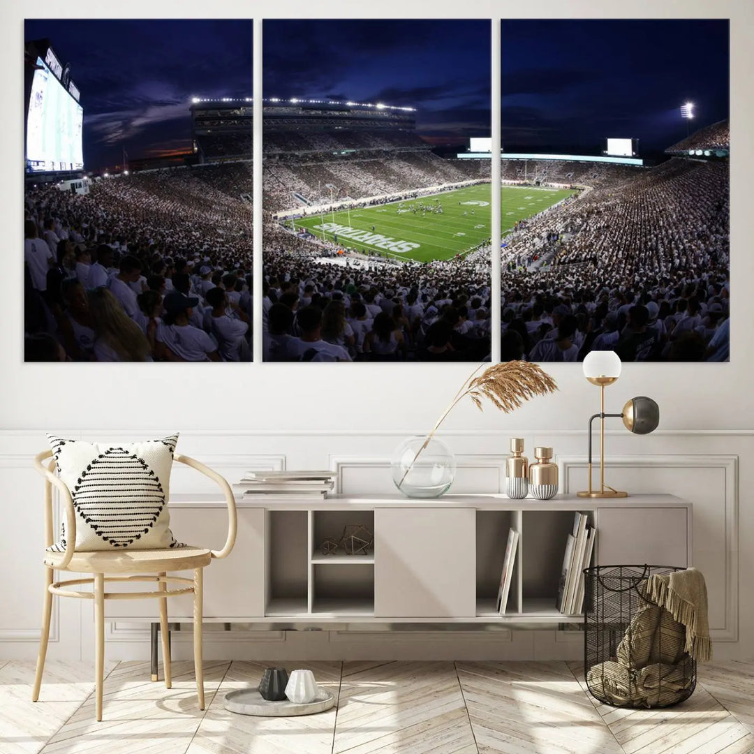 The living room features a wall adorned with a triptych of the Michigan State Spartans Football Team Print - East Lansing Spartan Stadium Wall Art Canvas Print.