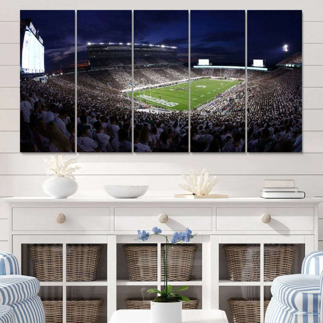 The living room features a wall adorned with a triptych of the Michigan State Spartans Football Team Print - East Lansing Spartan Stadium Wall Art Canvas Print.