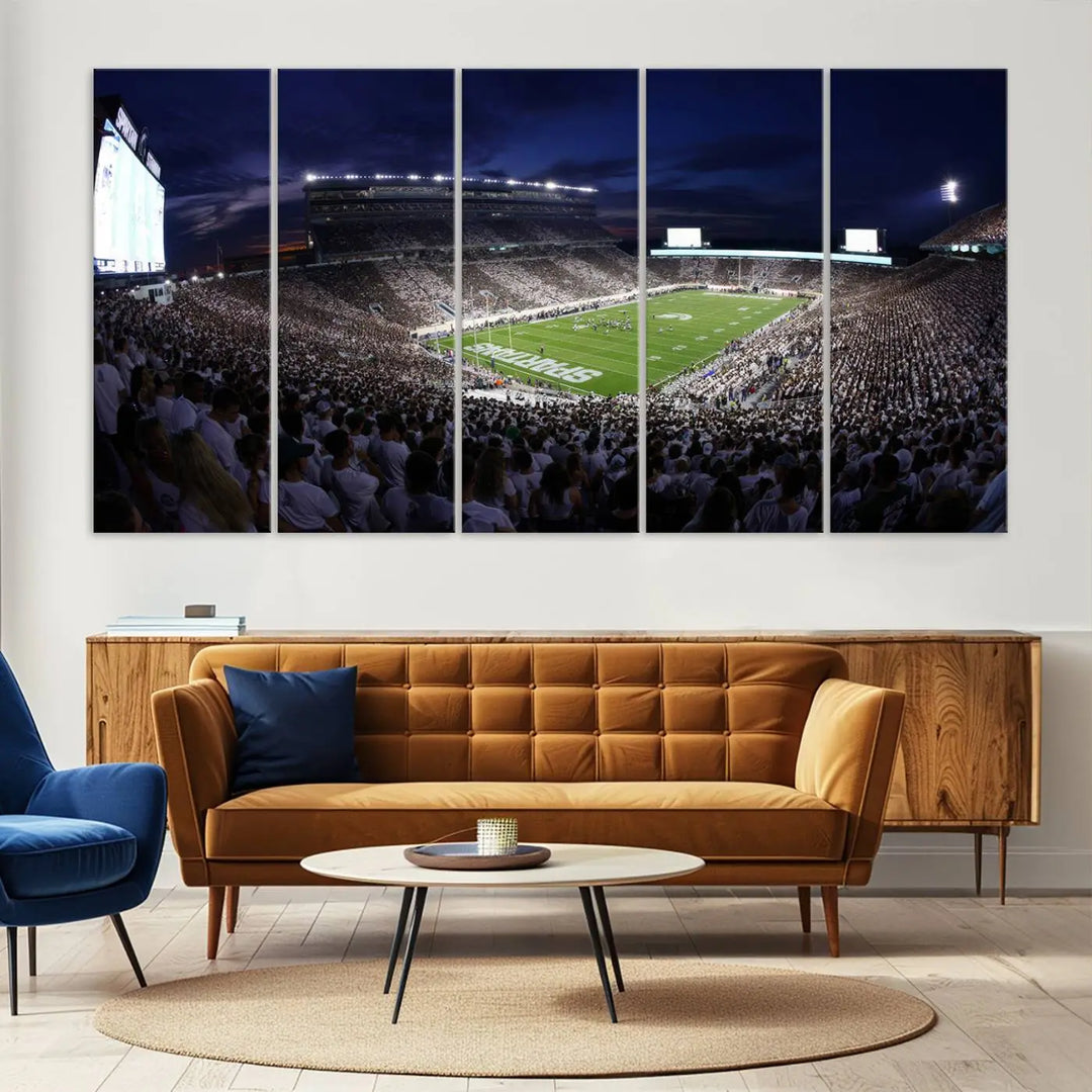 The living room features a wall adorned with a triptych of the Michigan State Spartans Football Team Print - East Lansing Spartan Stadium Wall Art Canvas Print.