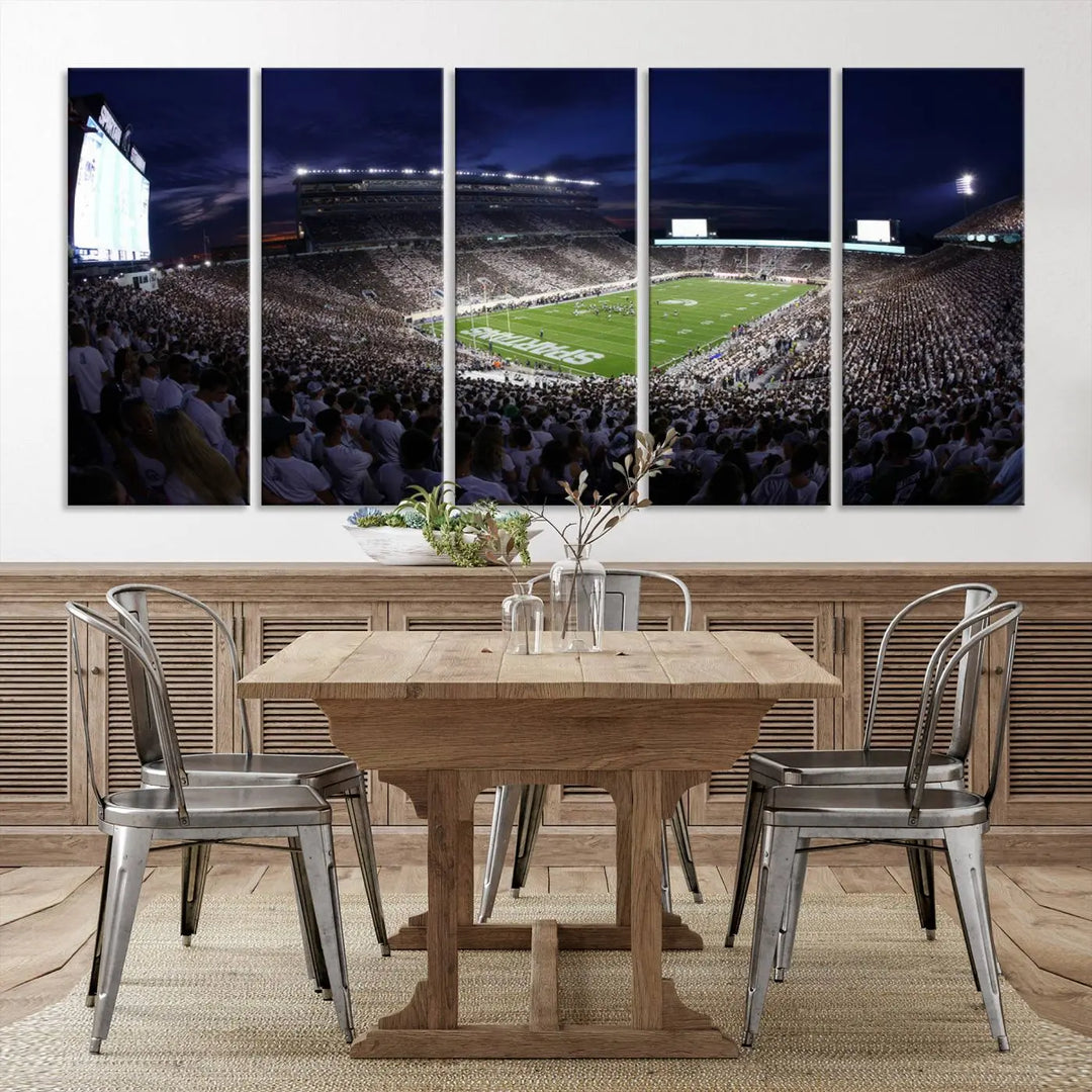 The living room features a wall adorned with a triptych of the Michigan State Spartans Football Team Print - East Lansing Spartan Stadium Wall Art Canvas Print.