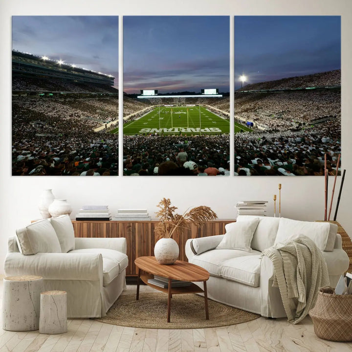 The living room features a Michigan State Spartans Football Team Print, a triptych canvas wall art depicting East Lansing's Spartan Stadium at dusk with a gallery-quality finish.