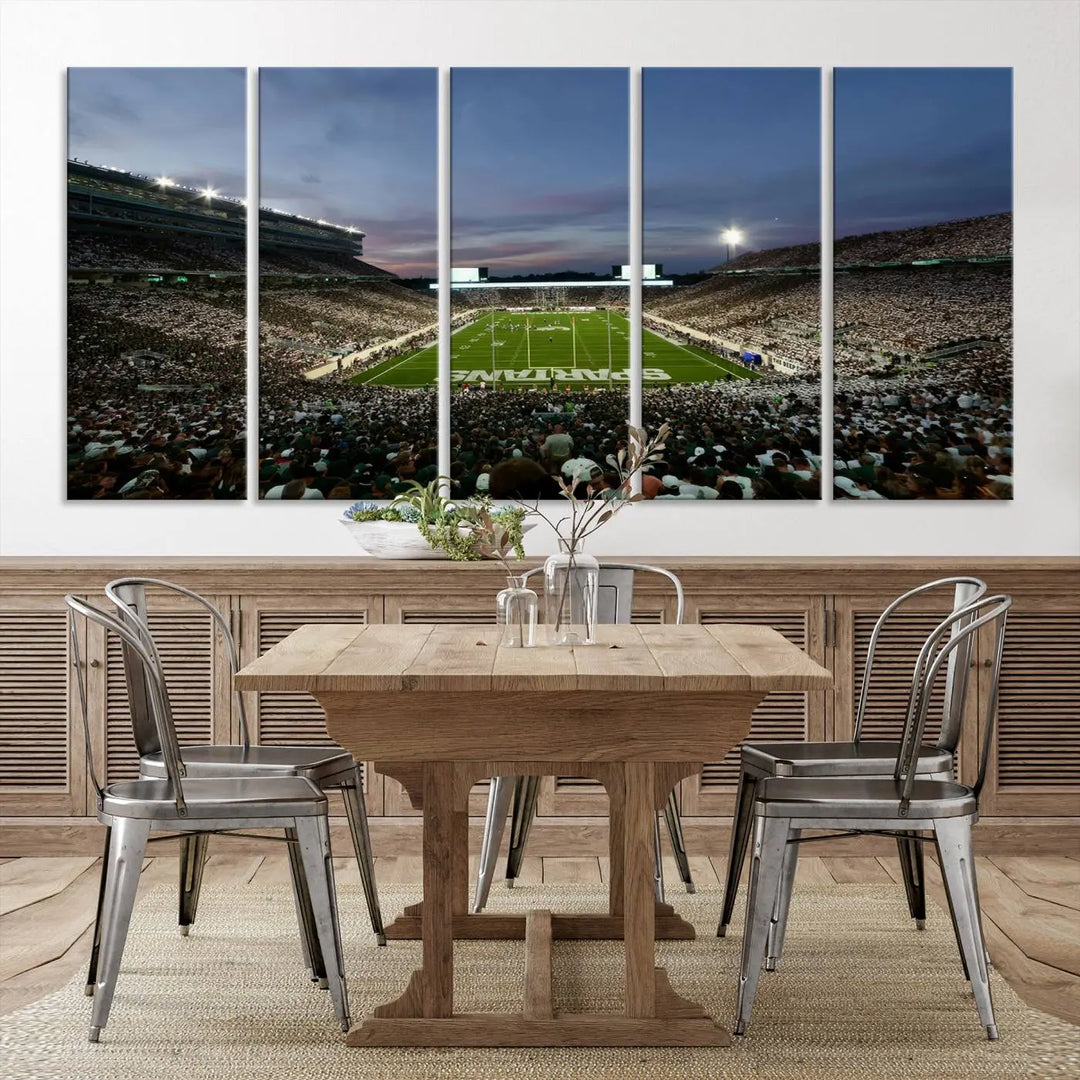 The living room features a Michigan State Spartans Football Team Print, a triptych canvas wall art depicting East Lansing's Spartan Stadium at dusk with a gallery-quality finish.