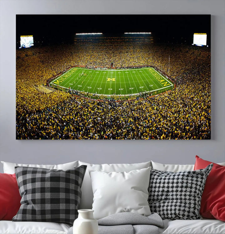 A triptych image vividly captures the electric energy of Michigan Stadium during a night game, with a sea of cheering fans. This Michigan Wolverines Football Team canvas print infuses any home with dynamic spirit and pride.