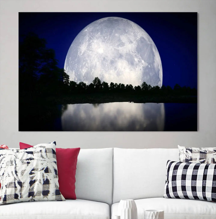 A modern living room showcases a three-panel MoonGlade Wall Art Canvas Print, depicting a moonlit night over a tranquil lake on museum-quality canvases.