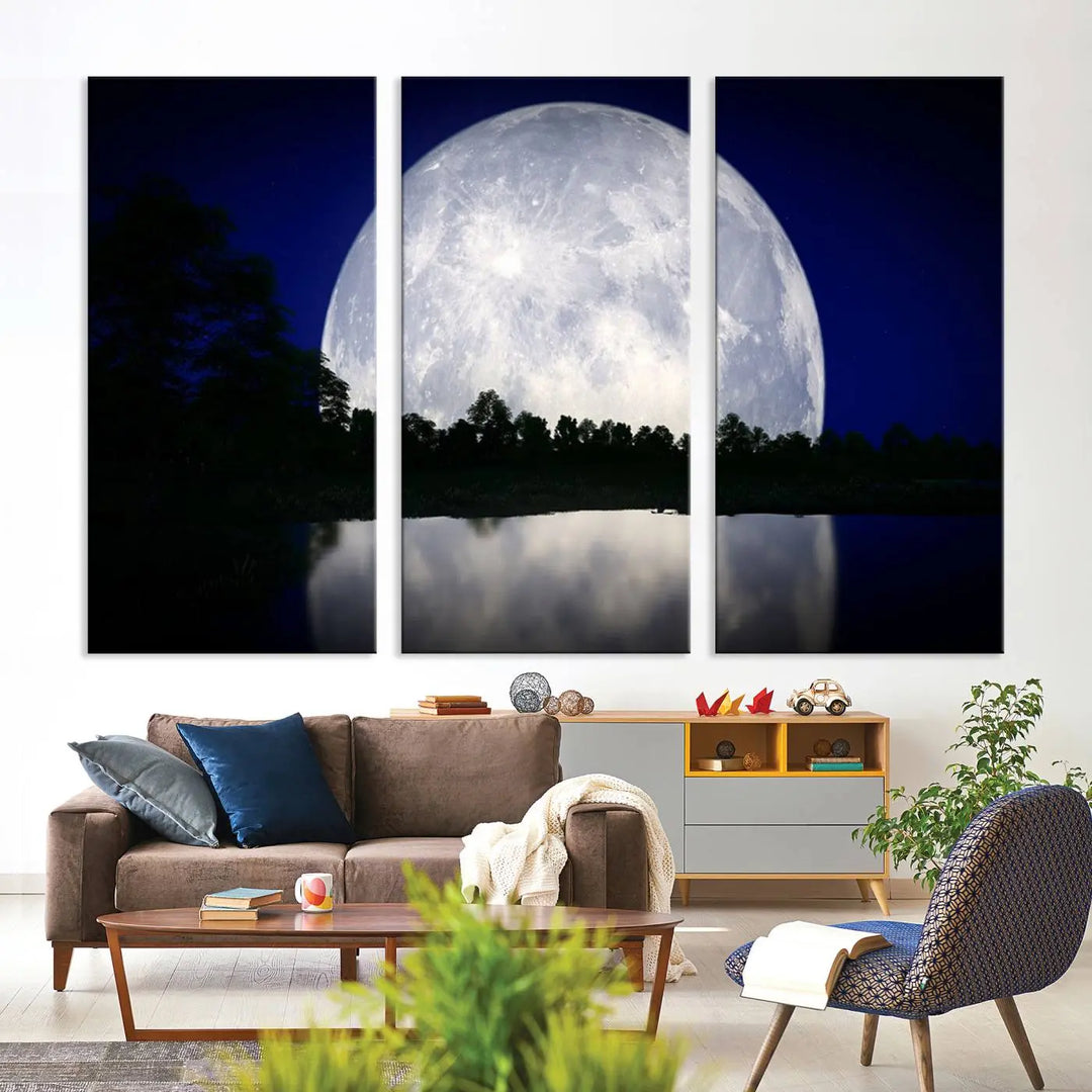 A modern living room showcases a three-panel MoonGlade Wall Art Canvas Print, depicting a moonlit night over a tranquil lake on museum-quality canvases.