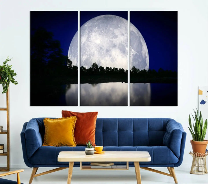 A modern living room showcases a three-panel MoonGlade Wall Art Canvas Print, depicting a moonlit night over a tranquil lake on museum-quality canvases.