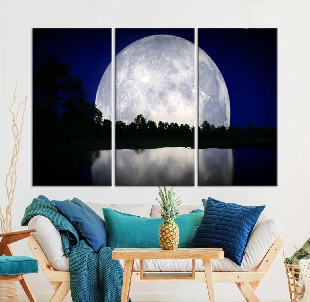 A modern living room showcases a three-panel MoonGlade Wall Art Canvas Print, depicting a moonlit night over a tranquil lake on museum-quality canvases.