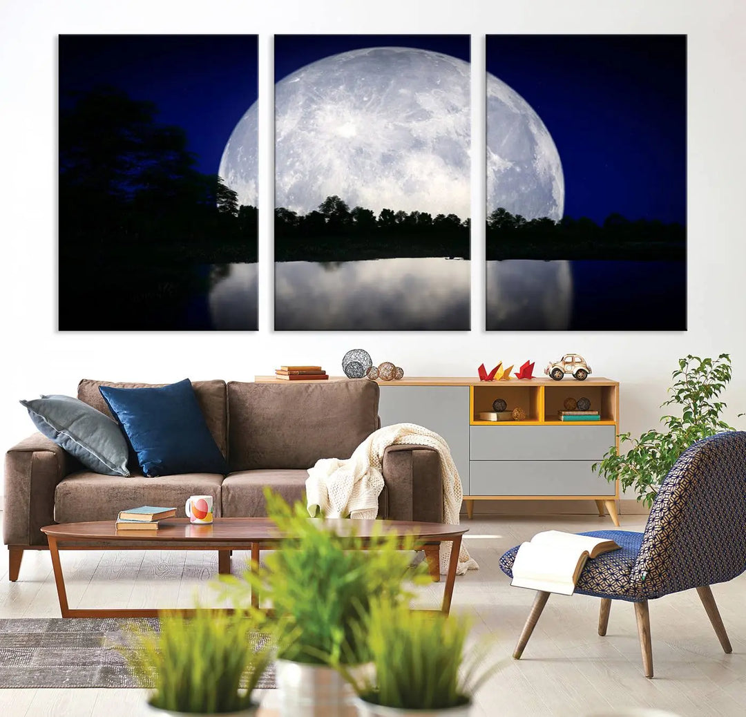 A modern living room showcases a three-panel MoonGlade Wall Art Canvas Print, depicting a moonlit night over a tranquil lake on museum-quality canvases.