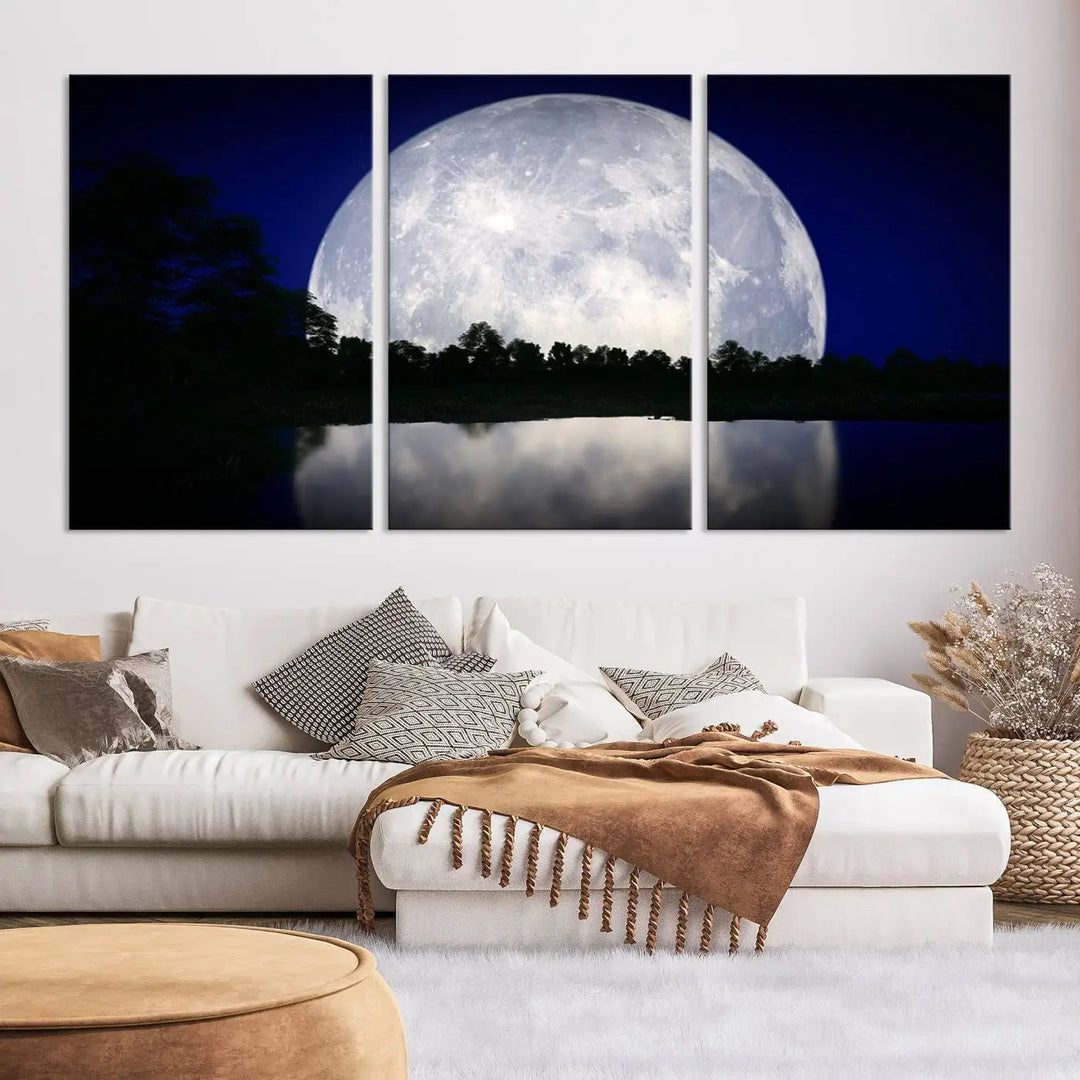 A modern living room showcases a three-panel MoonGlade Wall Art Canvas Print, depicting a moonlit night over a tranquil lake on museum-quality canvases.