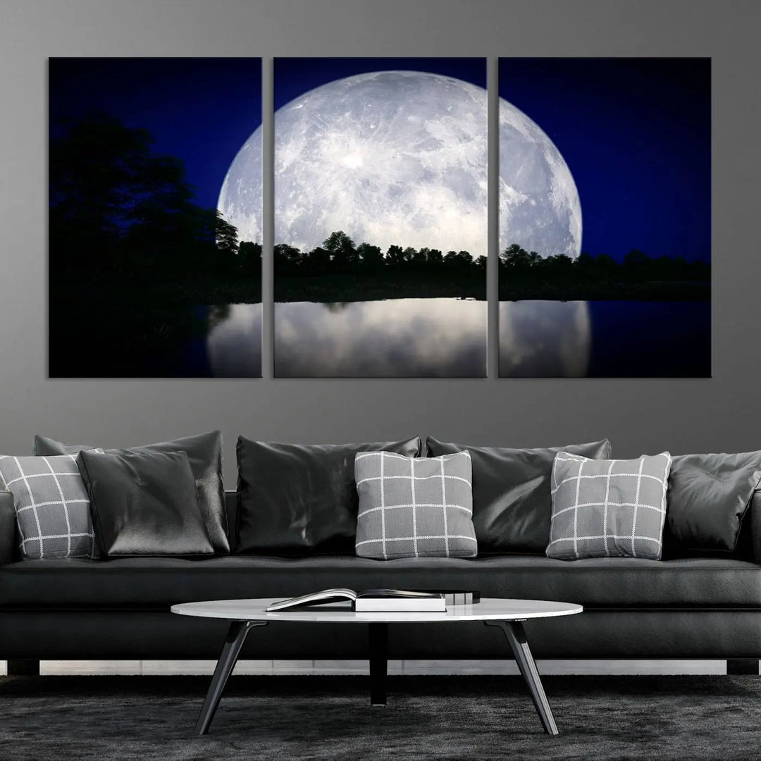 A modern living room showcases a three-panel MoonGlade Wall Art Canvas Print, depicting a moonlit night over a tranquil lake on museum-quality canvases.