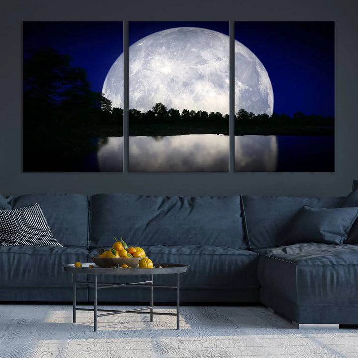 A modern living room showcases a three-panel MoonGlade Wall Art Canvas Print, depicting a moonlit night over a tranquil lake on museum-quality canvases.