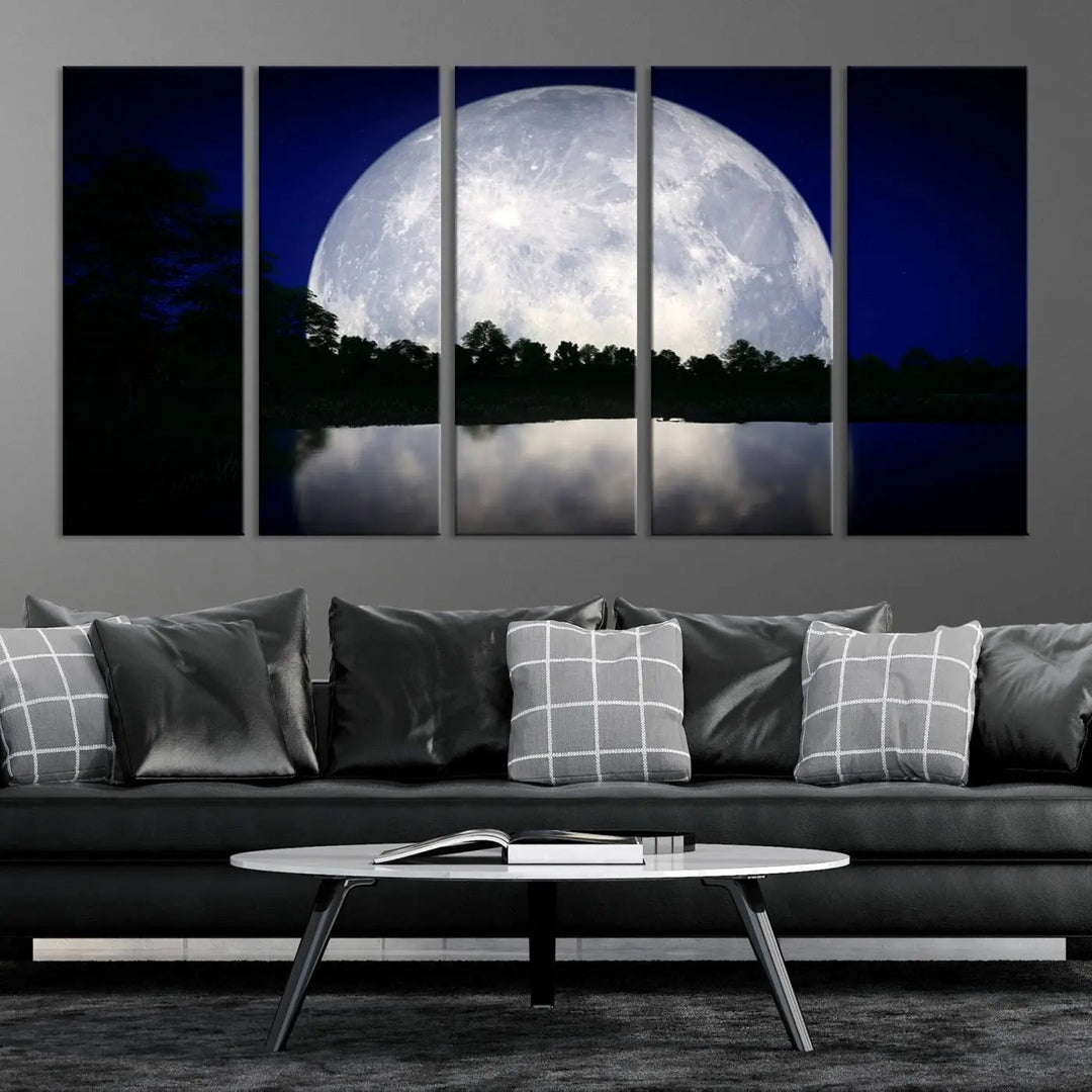 A modern living room showcases a three-panel MoonGlade Wall Art Canvas Print, depicting a moonlit night over a tranquil lake on museum-quality canvases.