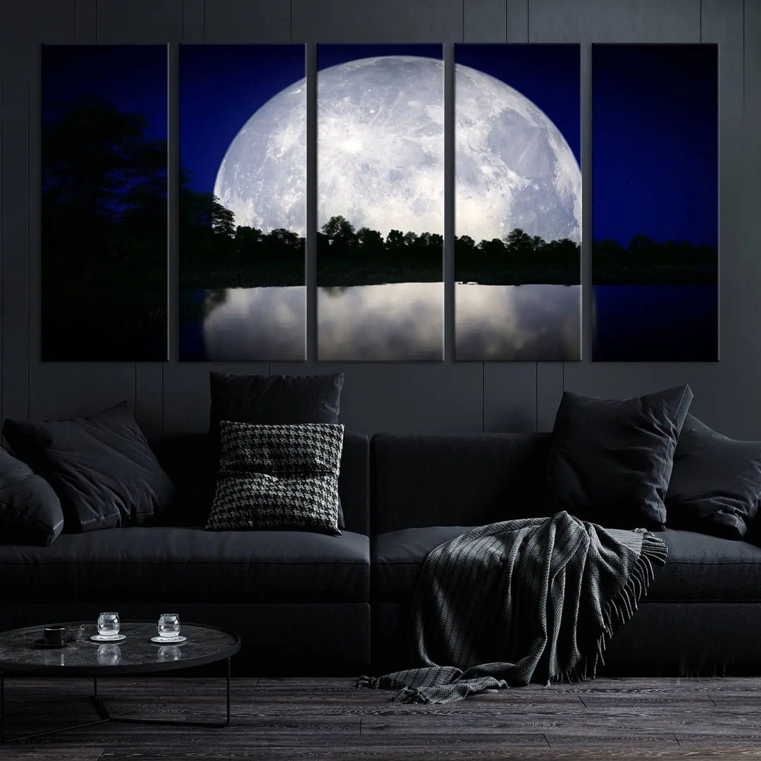 A modern living room showcases a three-panel MoonGlade Wall Art Canvas Print, depicting a moonlit night over a tranquil lake on museum-quality canvases.