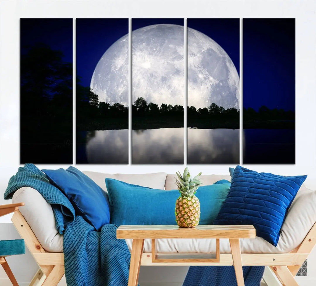 A modern living room showcases a three-panel MoonGlade Wall Art Canvas Print, depicting a moonlit night over a tranquil lake on museum-quality canvases.