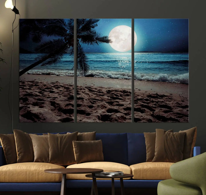 The living room features the Moonglade Coastal Palm Tree Wall Art Canvas Print adorning the wall. This triptych showcases palm trees and ocean waves on museum-quality canvases, enhanced with a UV-protective coating to maintain its vibrant colors.