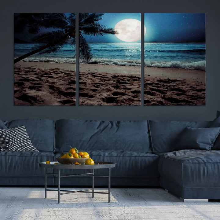 The living room features the Moonglade Coastal Palm Tree Wall Art Canvas Print adorning the wall. This triptych showcases palm trees and ocean waves on museum-quality canvases, enhanced with a UV-protective coating to maintain its vibrant colors.