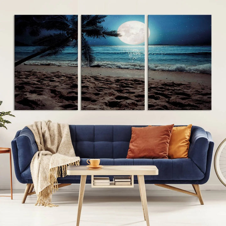 The living room features the Moonglade Coastal Palm Tree Wall Art Canvas Print adorning the wall. This triptych showcases palm trees and ocean waves on museum-quality canvases, enhanced with a UV-protective coating to maintain its vibrant colors.