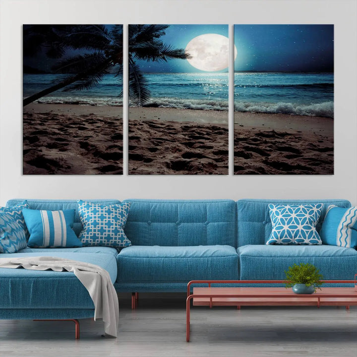 The living room features the Moonglade Coastal Palm Tree Wall Art Canvas Print adorning the wall. This triptych showcases palm trees and ocean waves on museum-quality canvases, enhanced with a UV-protective coating to maintain its vibrant colors.