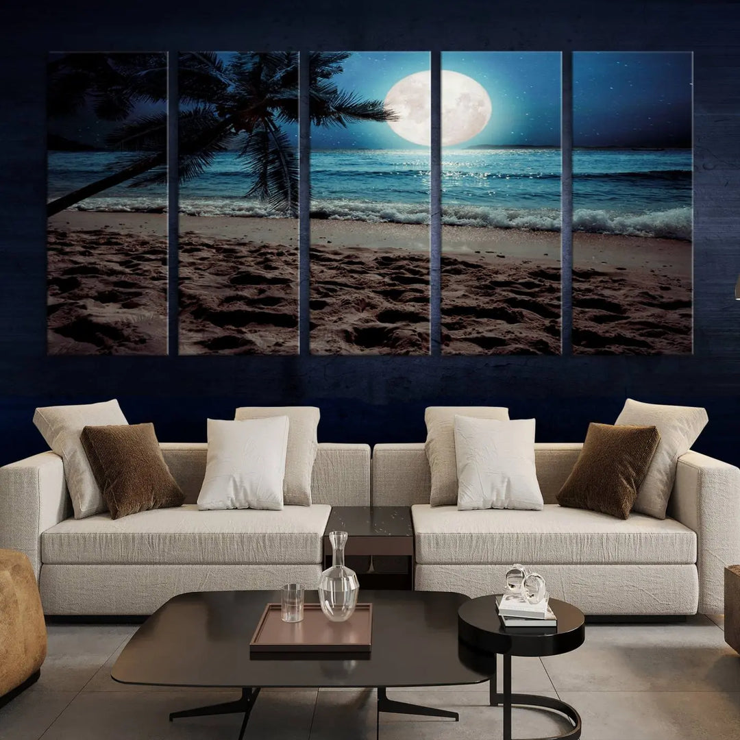 The living room features the Moonglade Coastal Palm Tree Wall Art Canvas Print adorning the wall. This triptych showcases palm trees and ocean waves on museum-quality canvases, enhanced with a UV-protective coating to maintain its vibrant colors.