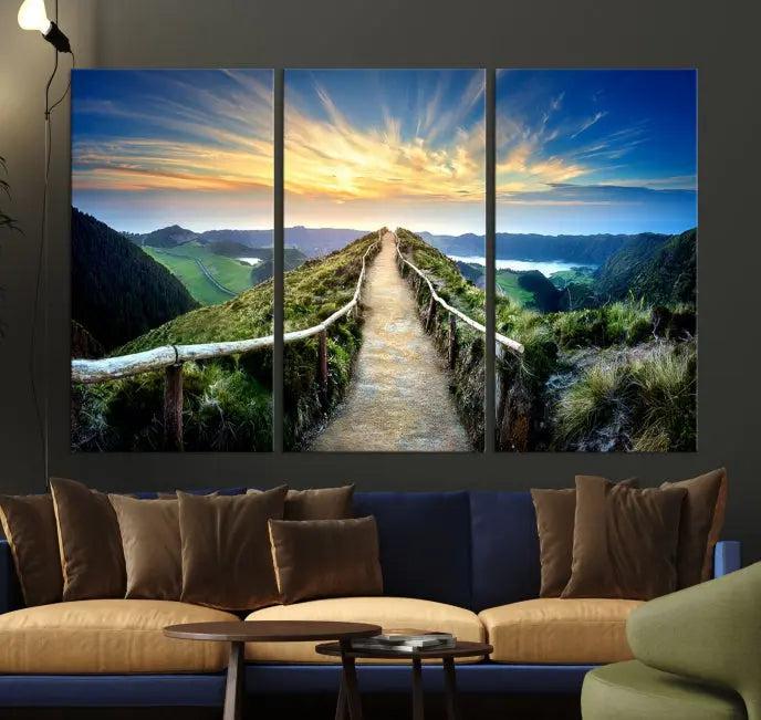 The Mountain Way Wall Art Canvas Print features a triptych of a sunrise over a mountain path. The artwork is gallery wrapped on museum-quality canvas, ensuring every detail shines through with stunning clarity and depth.