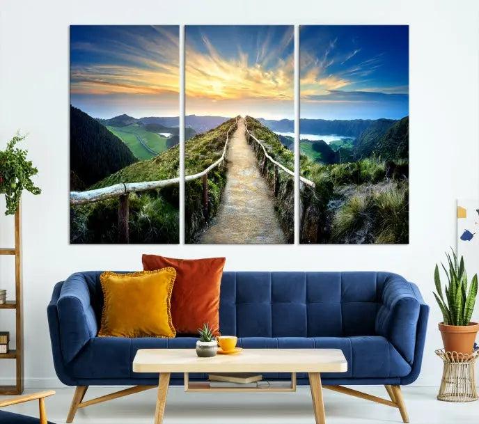 The Mountain Way Wall Art Canvas Print features a triptych of a sunrise over a mountain path. The artwork is gallery wrapped on museum-quality canvas, ensuring every detail shines through with stunning clarity and depth.