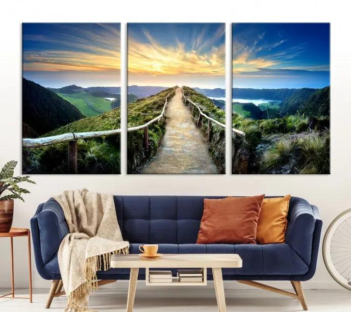 The Mountain Way Wall Art Canvas Print features a triptych of a sunrise over a mountain path. The artwork is gallery wrapped on museum-quality canvas, ensuring every detail shines through with stunning clarity and depth.