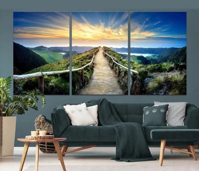 The Mountain Way Wall Art Canvas Print features a triptych of a sunrise over a mountain path. The artwork is gallery wrapped on museum-quality canvas, ensuring every detail shines through with stunning clarity and depth.