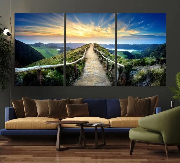 The Mountain Way Wall Art Canvas Print features a triptych of a sunrise over a mountain path. The artwork is gallery wrapped on museum-quality canvas, ensuring every detail shines through with stunning clarity and depth.