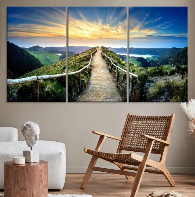 The Mountain Way Wall Art Canvas Print features a triptych of a sunrise over a mountain path. The artwork is gallery wrapped on museum-quality canvas, ensuring every detail shines through with stunning clarity and depth.