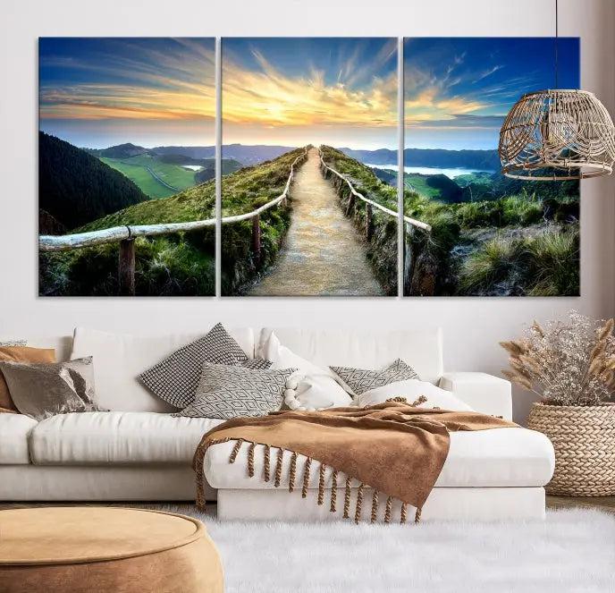 The Mountain Way Wall Art Canvas Print features a triptych of a sunrise over a mountain path. The artwork is gallery wrapped on museum-quality canvas, ensuring every detail shines through with stunning clarity and depth.