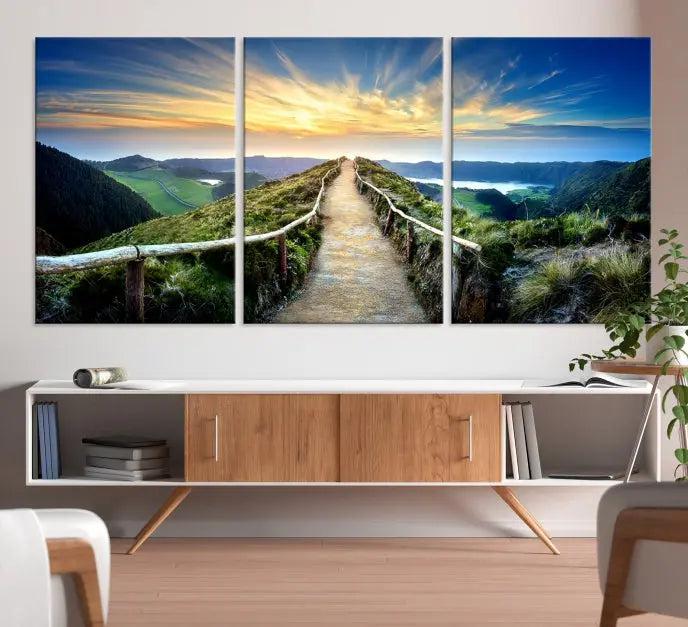 The Mountain Way Wall Art Canvas Print features a triptych of a sunrise over a mountain path. The artwork is gallery wrapped on museum-quality canvas, ensuring every detail shines through with stunning clarity and depth.