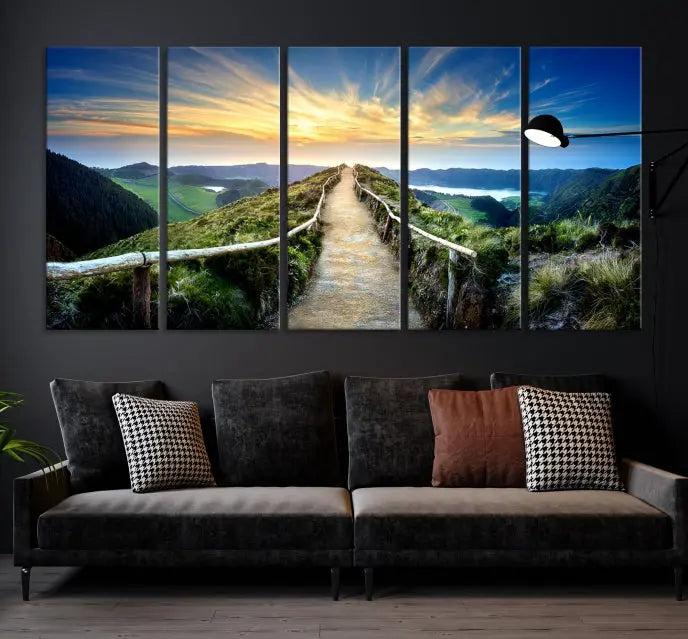 The Mountain Way Wall Art Canvas Print features a triptych of a sunrise over a mountain path. The artwork is gallery wrapped on museum-quality canvas, ensuring every detail shines through with stunning clarity and depth.