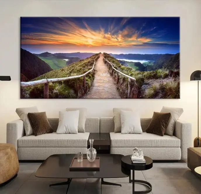 The Mountain and Sunset Wall Art Canvas Print, featuring a three-panel design on museum-quality canvas, captures a stunning sunset over a mountain path with a wooden railing. The hand-assembled frame ensures an exquisite finish and arrives ready to hang, adding natural beauty to any environment.